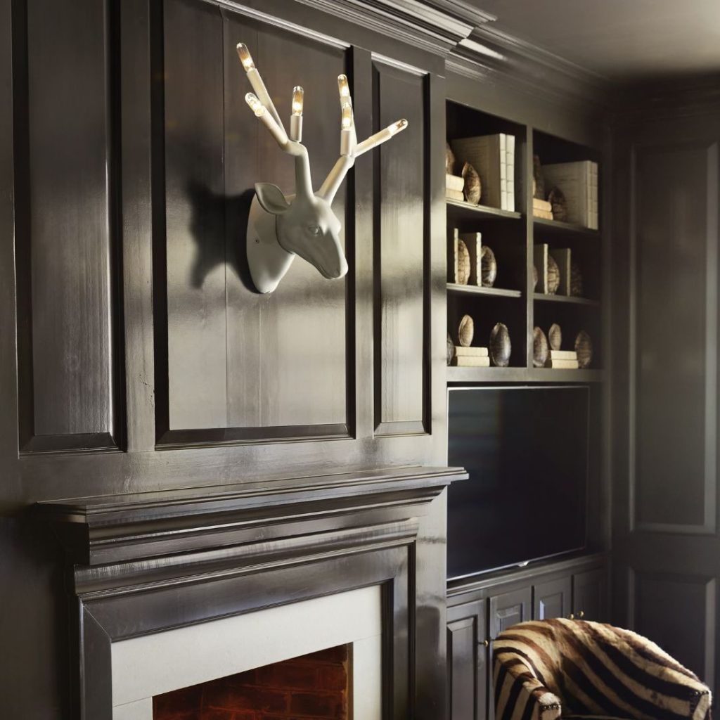 unique stag head light over a mantle